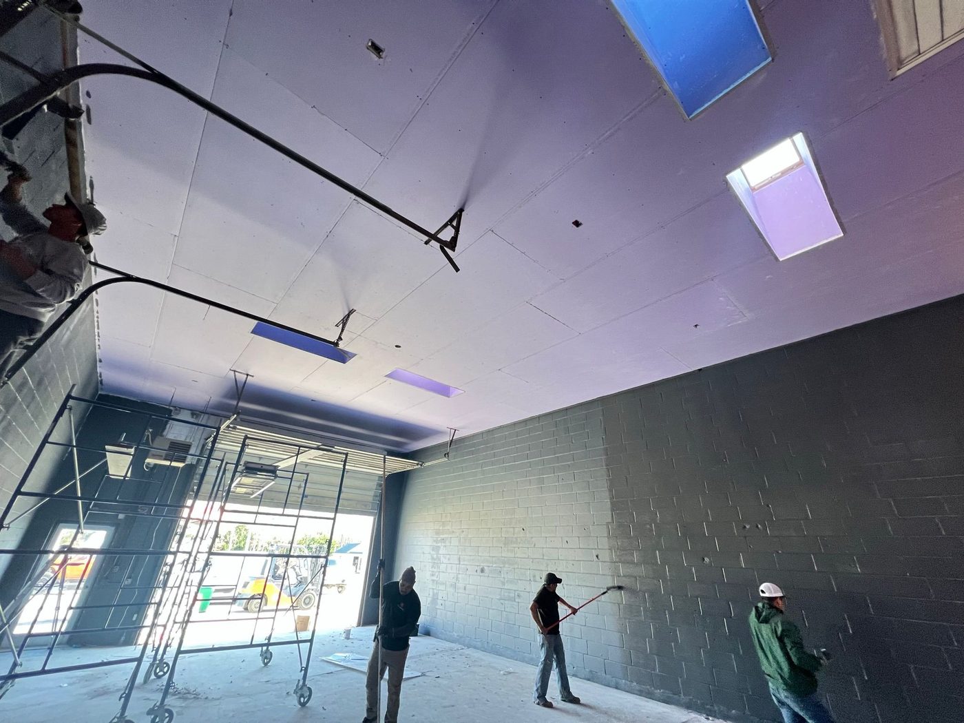 Commercial space with boarded ceiling by M&A Drywall